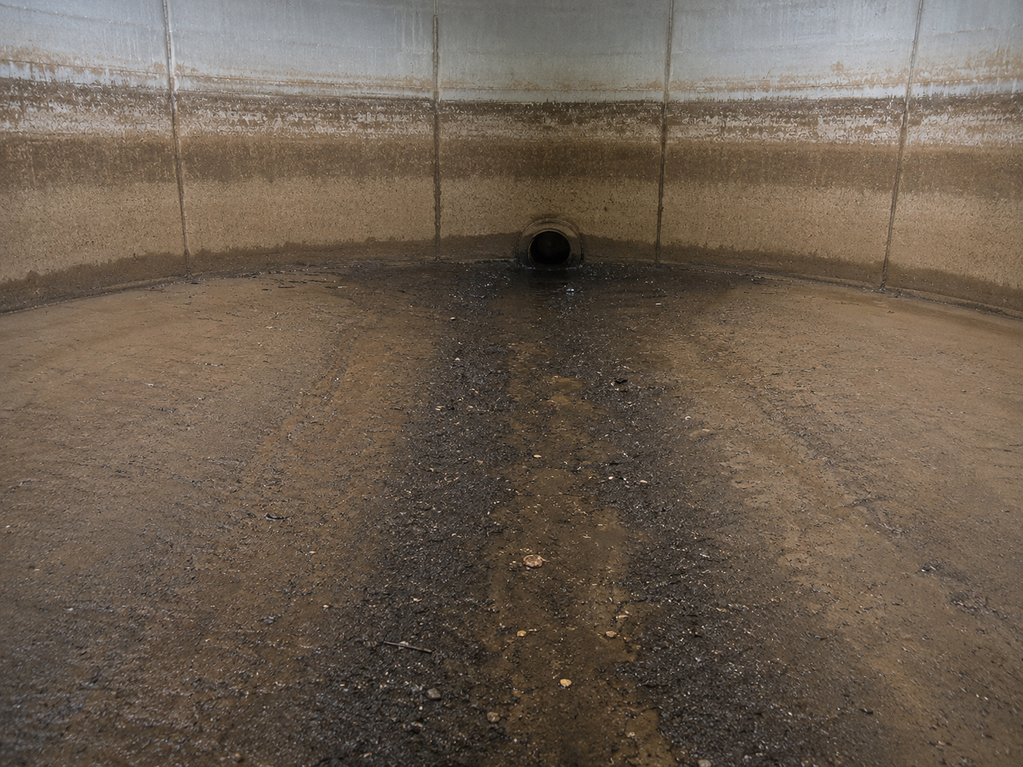 Sediment build-up near the outlet area of a potable water tank